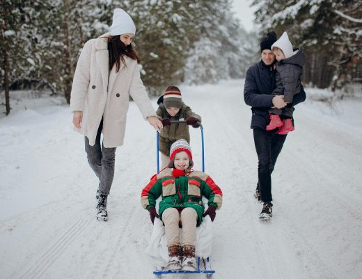 family of five having fun together in the snow in Alaska