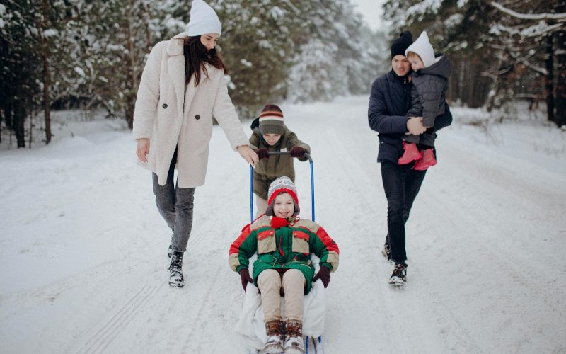 family of five having fun together in the snow in Alaska
