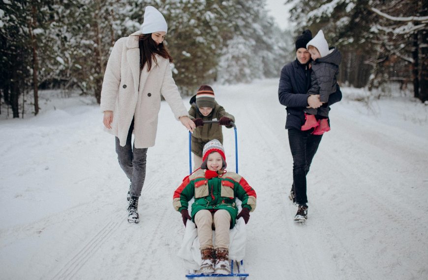 family of five having fun together in the snow in Alaska