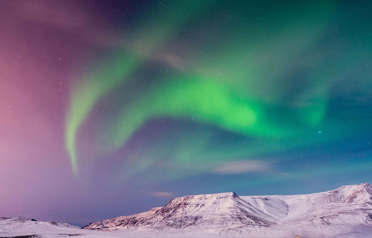 northern lights over snow-covered mountains